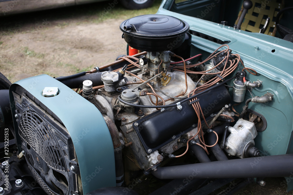 Fototapeta premium Powerful gasoline engine and cooling system of the SUV which is in the process of repair.