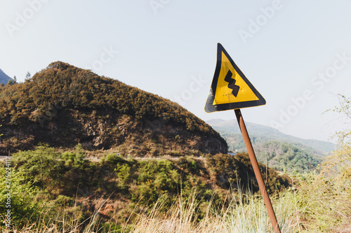 Warning road sign on mountain road