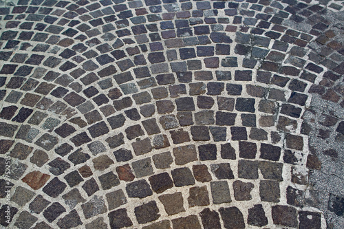 Stone pavement texture. Abstract background of old cobblestone pavement close-up