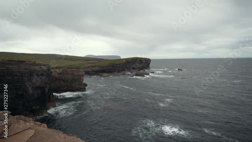 Waves splasing at the cliffs of orkney island. photo