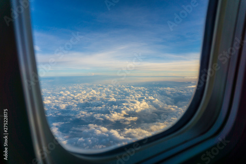 Obraz na plátně Aerial view sky and clouds through the plane illuminator after aircraft take off
