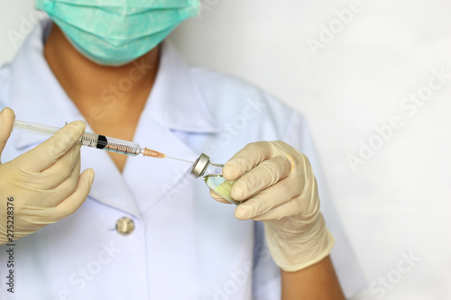 Doctor hand holding draw syringe and medicine bottle on white background  Medicine concept