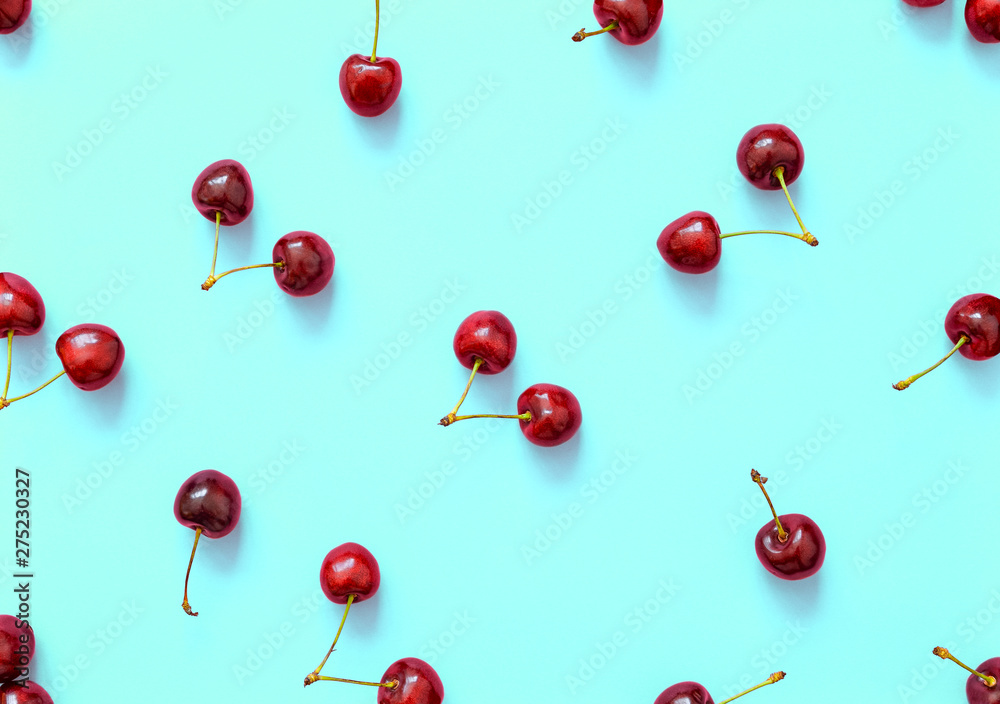 Big sweet cherry on a bright background. Cherries close up. Summer flat lay berry background. Top view cherry pattern.
