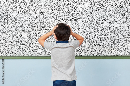 Child with dyslexia in front of whiteboard in elementary school photo