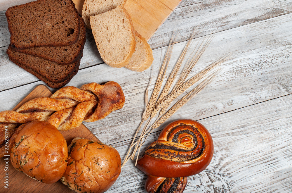 set of bread and pastries on a light wooden background. set of bread and pastries on a light wooden background.