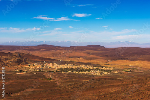 View over a village in Morocco with snowy Atlas mountains in the background