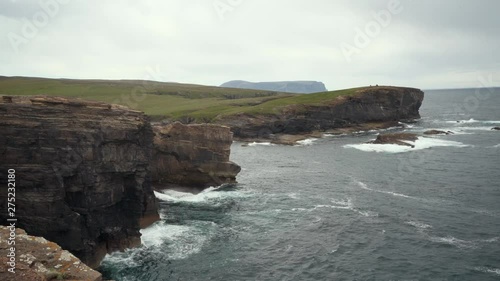 Waves splasing at the cliffs of orkney island. photo
