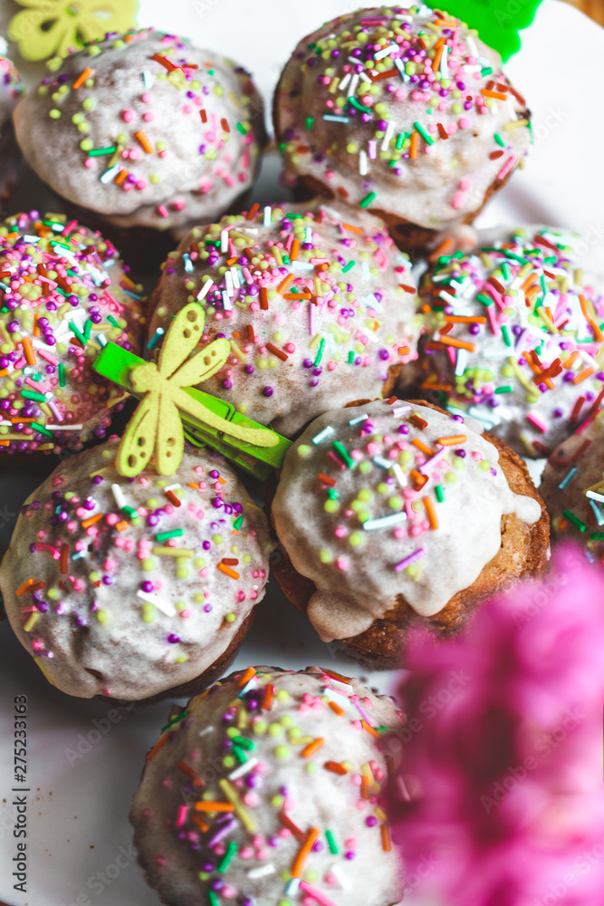 Cupcakes with multi-colored sprinkles close-up. Easter Day celebration. Holiday dinner Cupcakes with multi-colored sprinkles close-up. Easter Day celebration. Holiday dinner