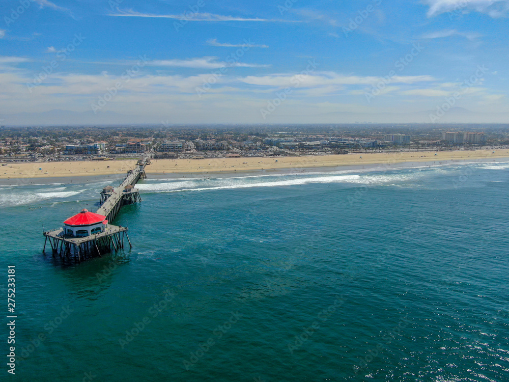 Aerial view of Huntington Pier, beach & coastline during sunny summer day, Southeast of Los Angeles. California. destination for surfer and tourist.
