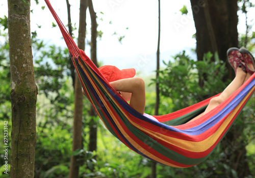 Relaxing in hammock in summer forest