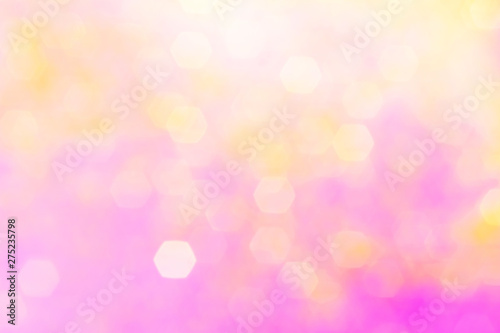 Blurred background - pink surface with gold sparkles. Abstract image. Bright color. Abstract circular bokeh.