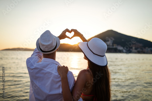 Happy couple in love walking on beach on honeymoon vacation photo