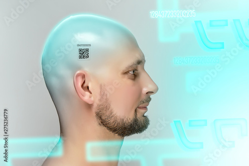 Profile of bald man with QR code on head on gray background in studio.