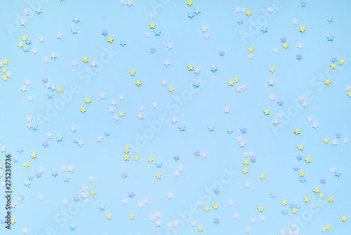 Little stars confetti on blue background. Holyday concept.