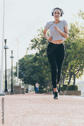 Healthy woman doing exercises and warm up before running and jogging at morning