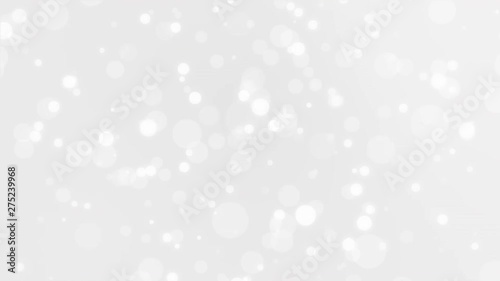 Beautiful festive silver white bokeh background with glowing light particles.