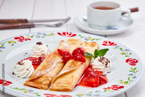 crepes with strawberry sauce and whipped cream photo