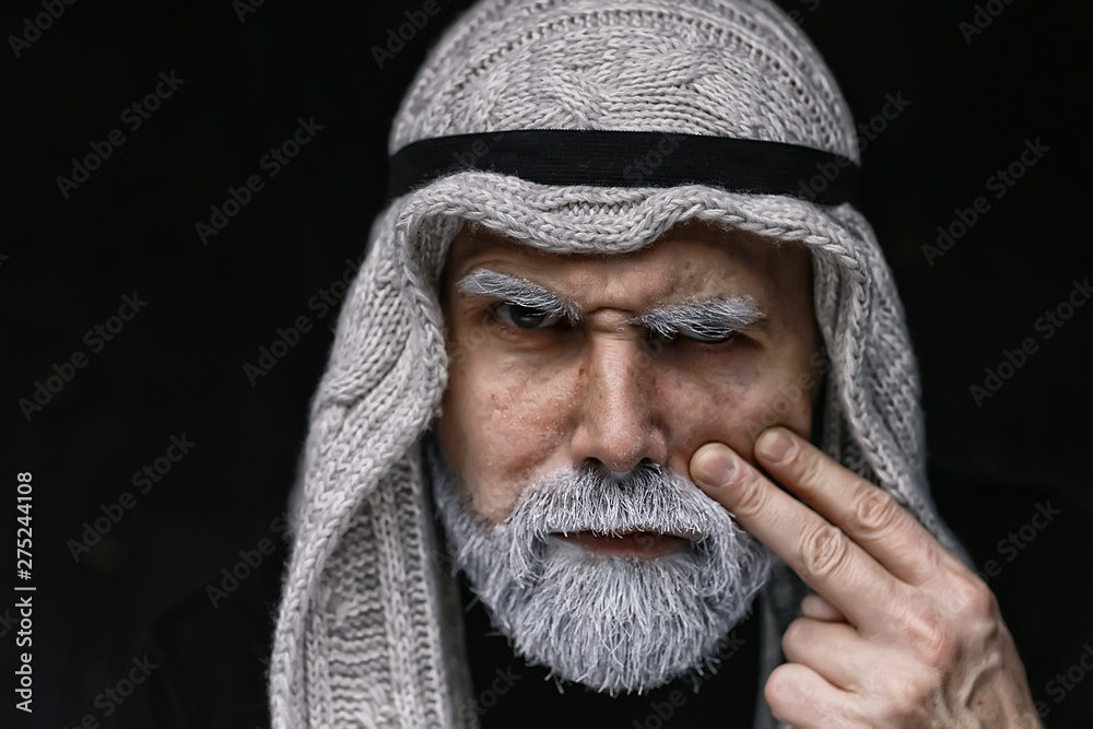 make-up man with a beard / concept oriental portrait in traditional dress, gray-haired white beard in an Arab man