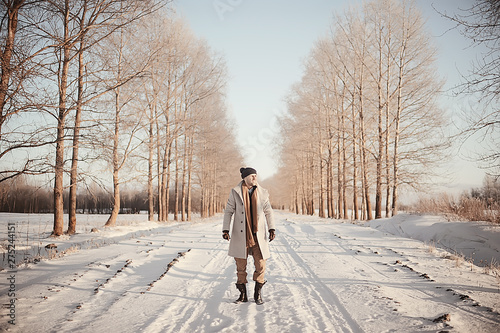 fashionable man in a coat / winter style, walk against the backdrop of the winter landscape, snowy weather, warm clothes