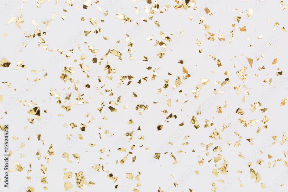 Golden confetti on white background. Festive, party or holiday glitter backdrop. Flat-lay, top view. - obrazy, fototapety, plakaty 