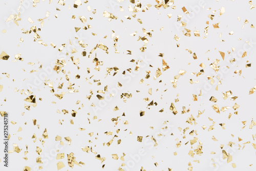 Photographie Golden confetti on white background