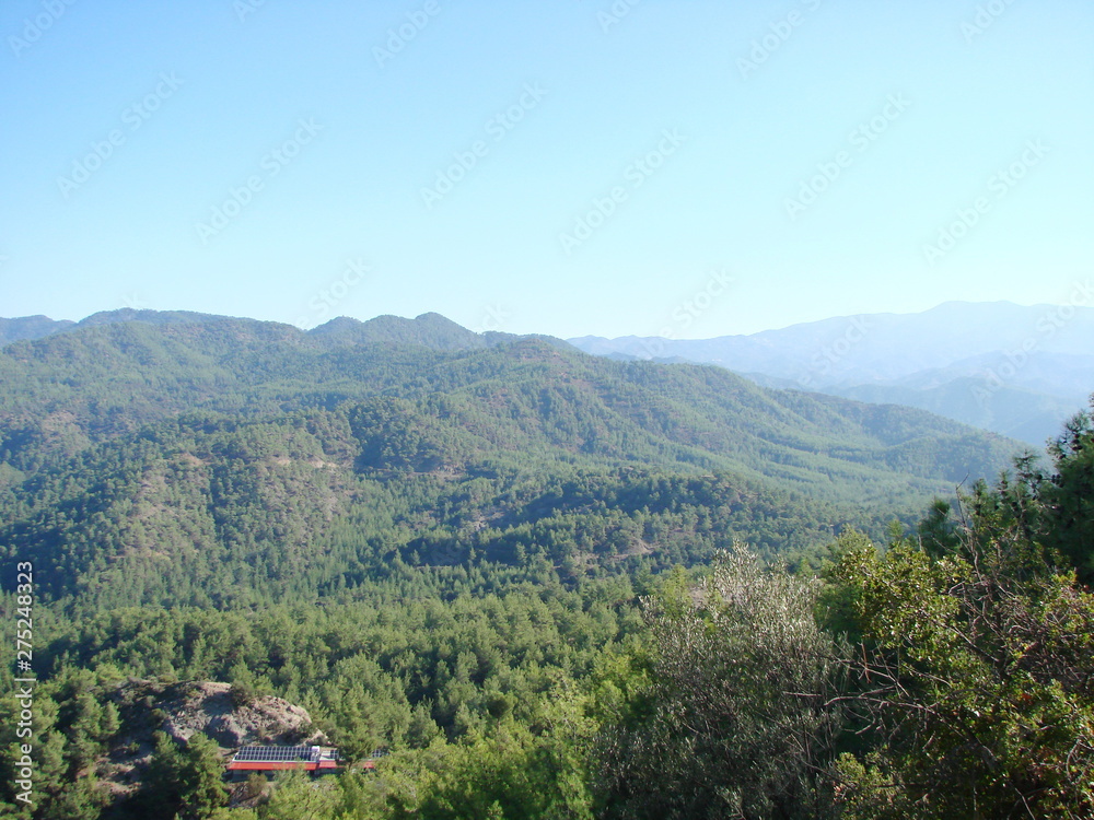 A panorama of pure blue sky over the mountain ranges with a bright sunrise that reaches the boundless horizon.
