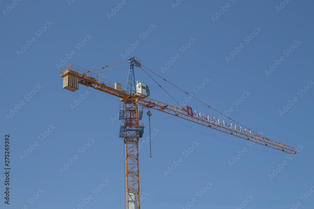 Construction site background. A crane in a construction work Construction site background. A crane in a construction work