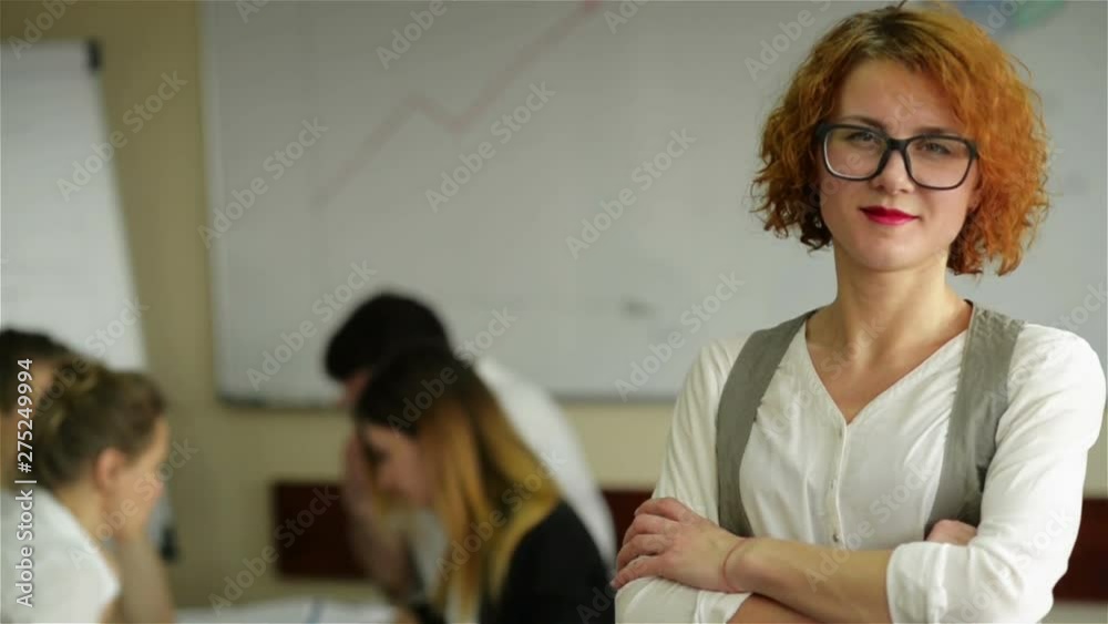 Portrait of young white woman in a busy modern workplace Portrait of young white woman in a busy modern workplace