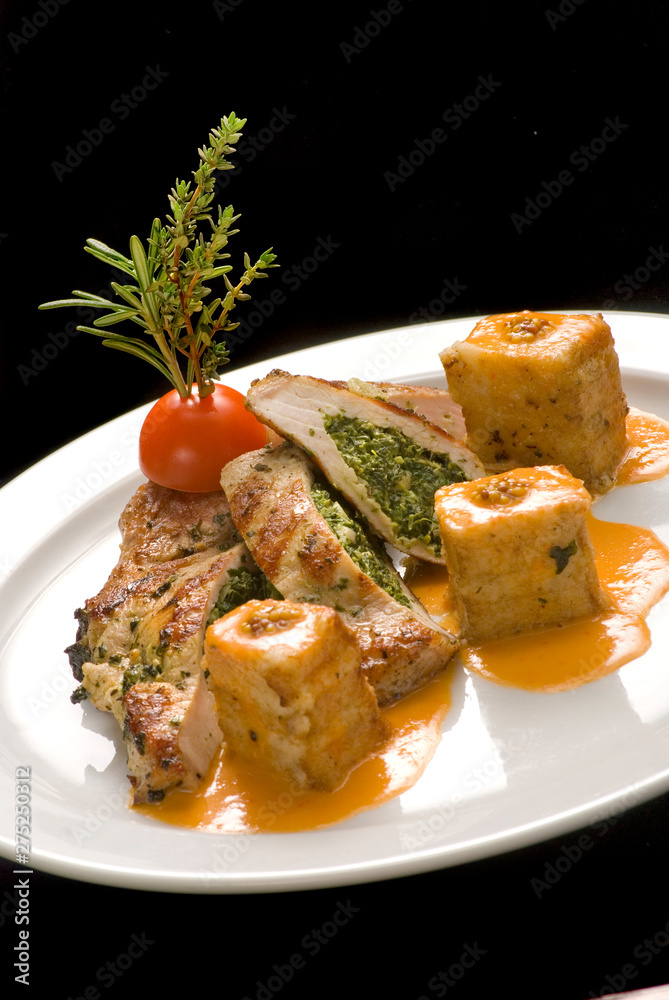 Turkey stuffed with spinach with couscous on a white plate Turkey stuffed with spinach with couscous on a white plate