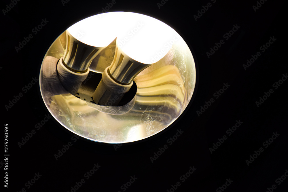 Shining light bulb on the ceiling