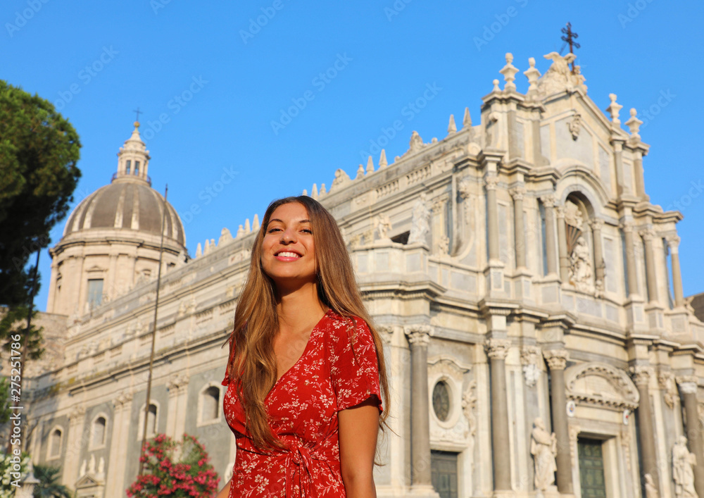 Smiling female tourist visiting Catania Cathedral in Sicily. Summer holidays in Italy.