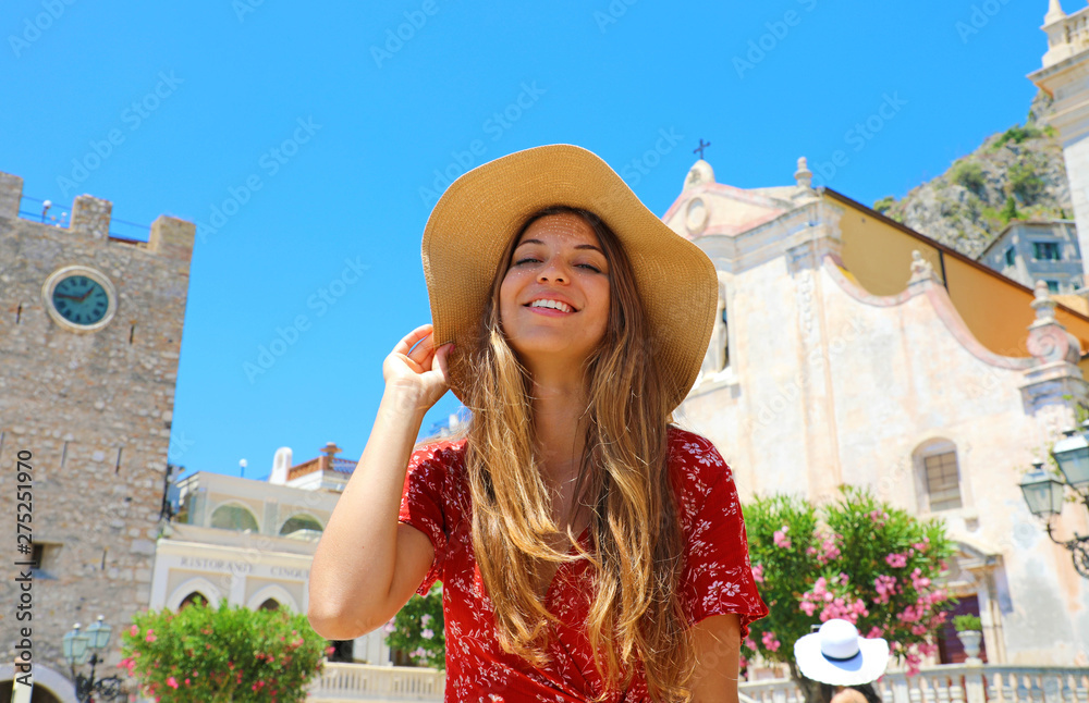 Smiling girl in main square of Taormina beautiful village on Sicily Island, Italy