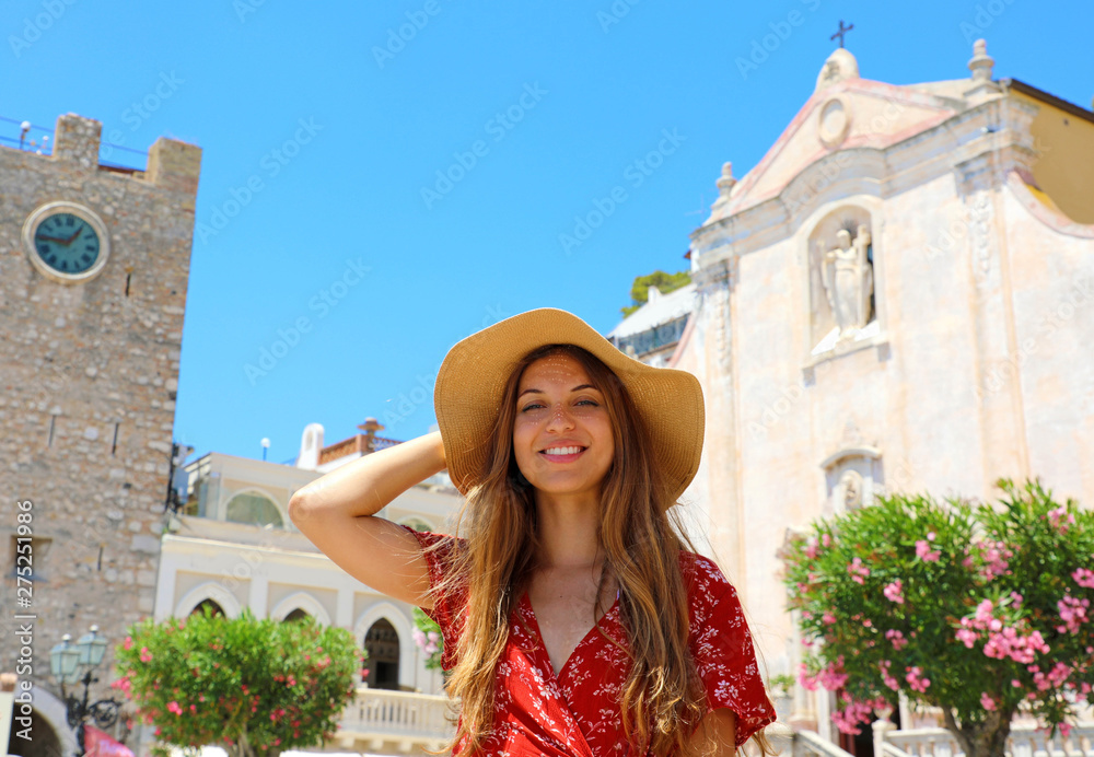 Beautiful smiling woman walking in Taormina village on Sicily Island, Italy