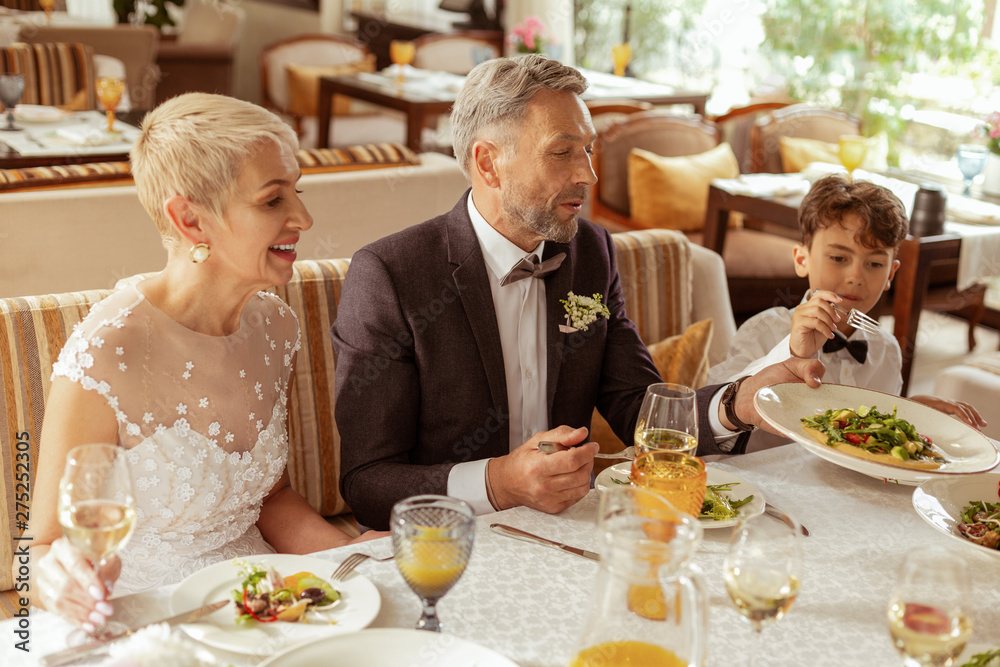 Aged bride sitting near husband while celebrating wedding Aged bride sitting near husband while celebrating wedding