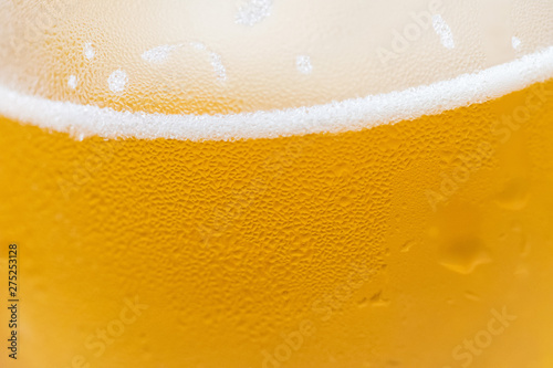 Closeup of a cold beer glass with condensation droplets on the surface