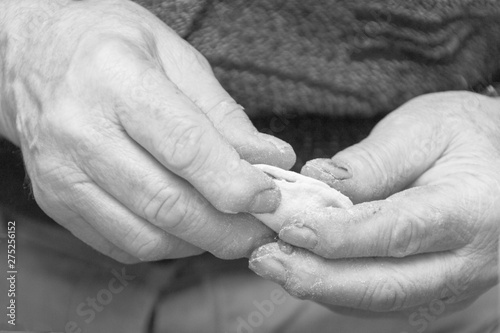 men hands concoct dumplings