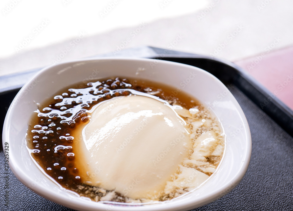 Popular Taiwan gourmet - Dessert of tapioca pearl ball (bubble) mixed bean curd tofu pudding (douhua, dou hua) in white bowl, close up, lifestyle Popular Taiwan gourmet - Dessert of tapioca pearl ball (bubble) mixed bean curd tofu pudding (douhua, dou hua) in white bowl, close up, lifestyle