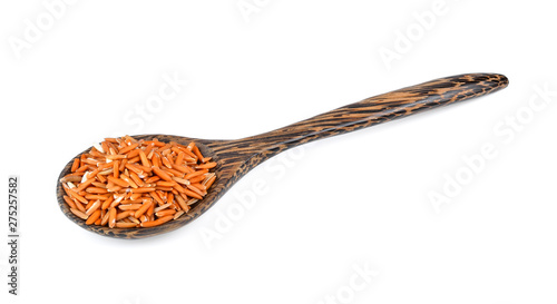 brown rice seed in wood spoon isolated on white background