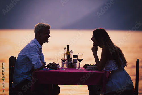 People  vacation  love and romance concept. Young couple enjoying a romantic dinner on beach.