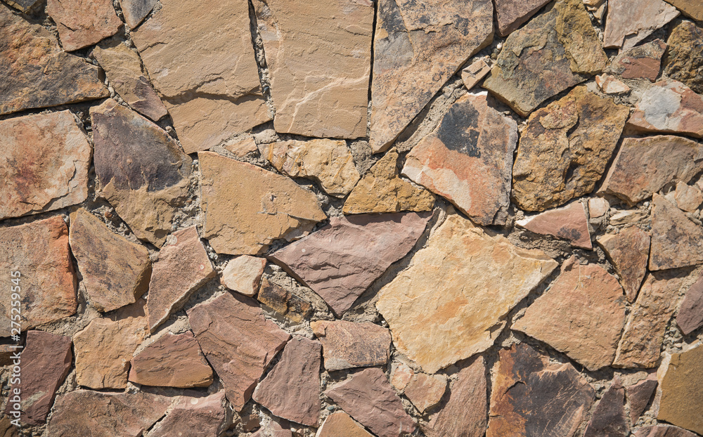 texture of a stone wall. decorative stone, different colors. tile on the floor. floor made of decorative multicolored tiles