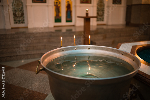 Wallpaper Mural Infant baptism. Preparation for the baptism of children. container with water. burning candle fire Torontodigital.ca