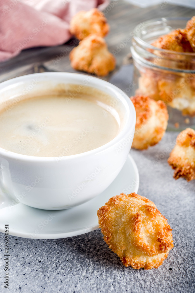 French coconut cookies congolais with coffee mug, grey stone or concrete background copy space French coconut cookies congolais with coffee mug, grey stone or concrete background copy space