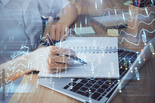 Financial charts displayed on woman's hand taking notes background. Concept of research. Double exposure