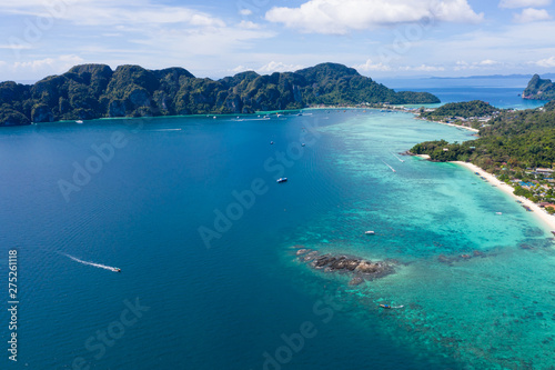 long tail and speed boat chartered for snorkelling at phi phi island in the tourist high season of phi phi island kra bi province Thailand