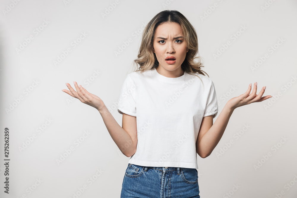 Portrait of a lovely young asian woman standing isolated Portrait of a lovely young asian woman standing isolated