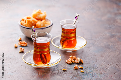 Traditional Turkish arabic dessert and a glass of tea with mint