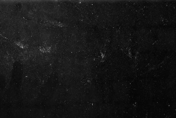 white dust and scratches on a black background. The texture of dirt on the glass.