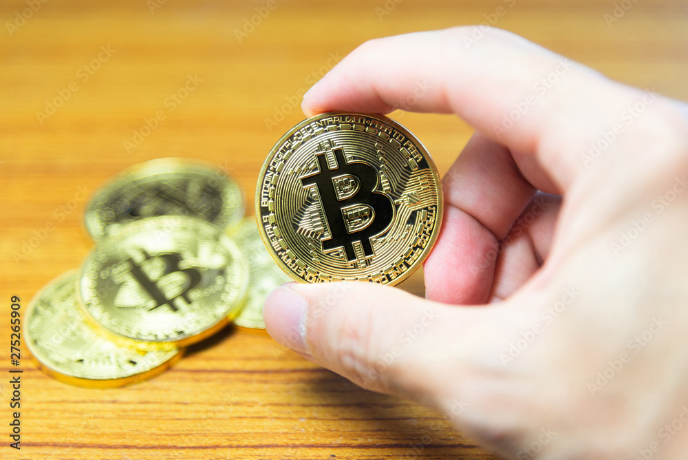 Bitcoin in hand with close up view. Digital money and Bitcoine concept. Bitcoin in hand with close up view. Digital money and Bitcoine concept.