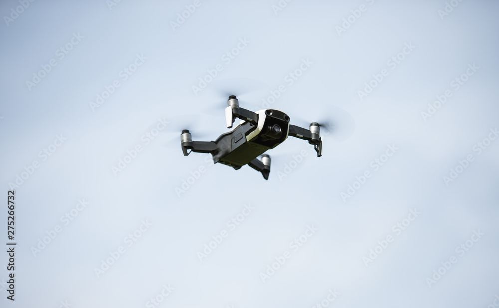 Black drone with propellers flies into the sky and photographs landscapes Black drone with propellers flies into the sky and photographs landscapes