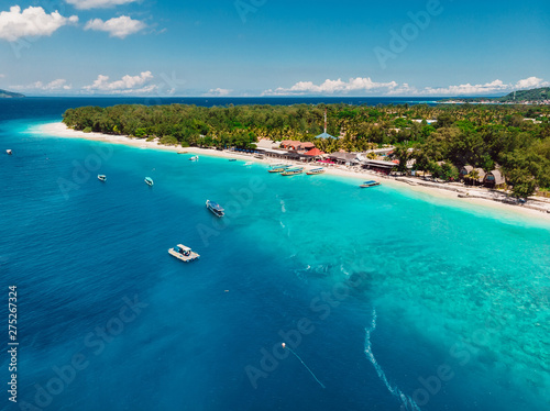 Tropical beach and turquoise ocean with boats. Aerial view. Paradise holiday resort